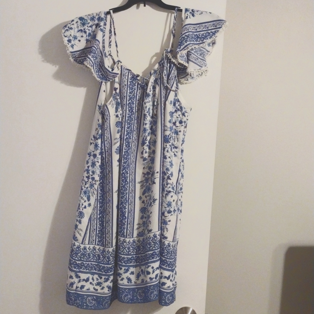 Super cute top with cold shoulder, flutter sleeves and lace-up neckline!